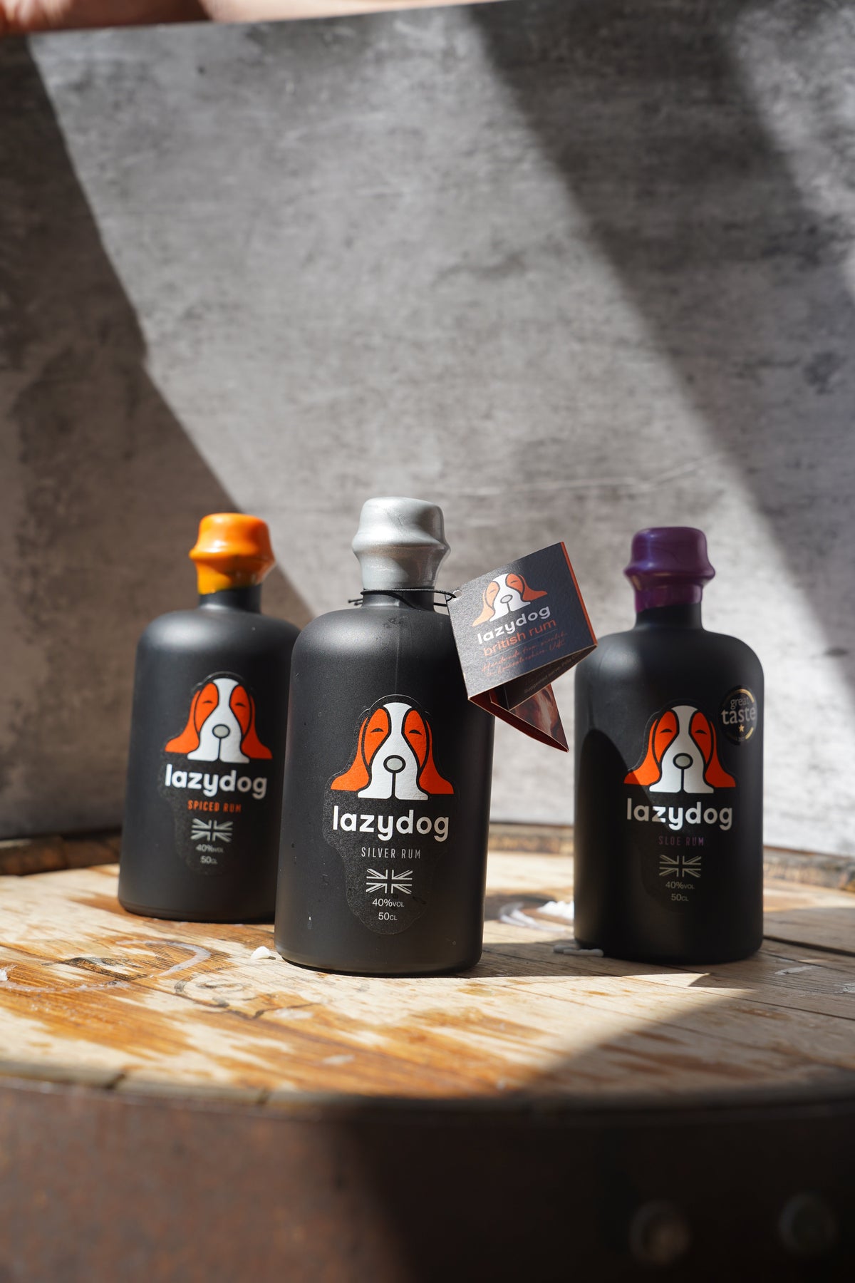 Lazydog rum bottles photographed on an oak cask