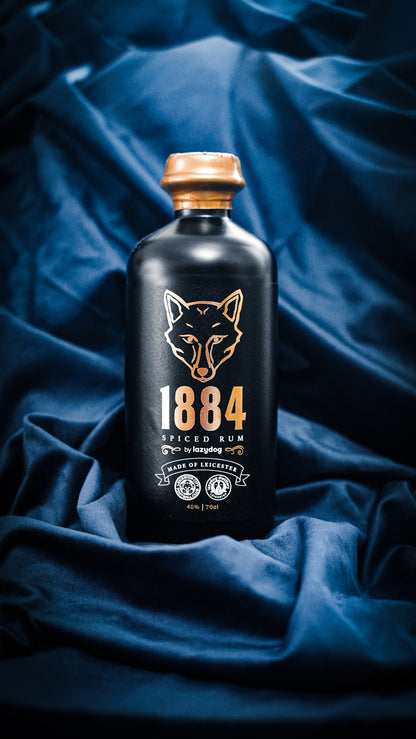Original photograph of 1884 Spiced Rum, black 70cl bottle with copper fox label and copper wax.